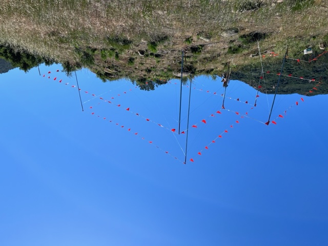 Hillside story poles with extensive red pennant flagging